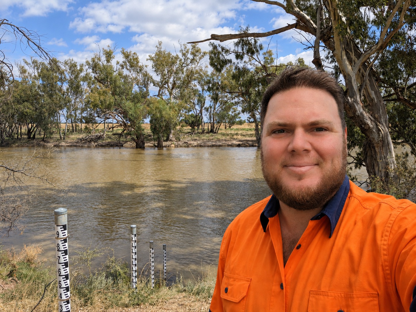Robbie Heane on the riverbank beside a run of staff gauges